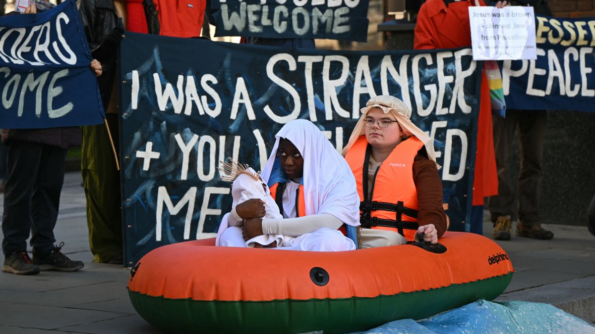 Young Christians hold a demonstration, depicting Jesus, Mary and Joseph as refugees in an inflatable dinghy boat, outside of St Paul&#039;s Cathedral in response to increasing anti-refugee politics and the growing rise of Christian nationalism in London, UK, Dec. 13, 2025. (AFP Photo)