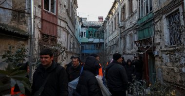 Residents stand near damaged apartment buildings at the site of a Russian missile and drone strike, amid Russia&#039;s attack on Ukraine, in Odesa, Ukraine Dec. 13, 2025. (Reuters Photo)