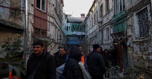 Residents stand near damaged apartment buildings at the site of a Russian missile and drone strike, amid Russia's attack on Ukraine, in Odesa, Ukraine Dec. 13, 2025. (Reuters Photo)