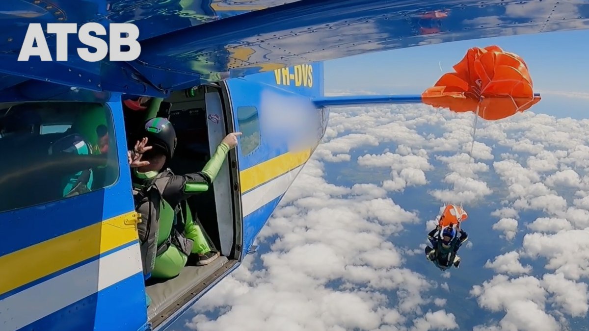 In this image taken from a video a skydiver is caught on the wing of a plane as he exited the aircraft in Tully, North Queensland, Australia, Sept. 20, 2025. (AP Photo)