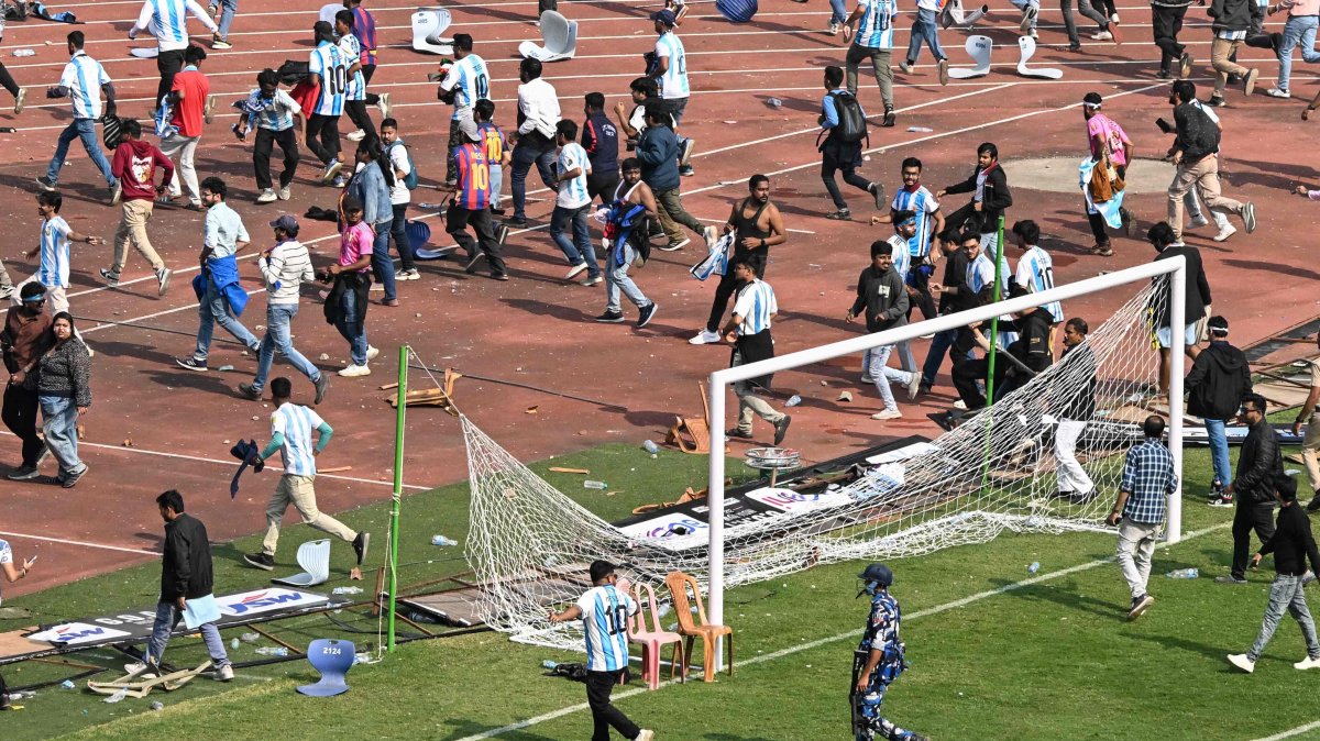 Security personnel try to control the crowd as Argentina's footballer Lionel Messi departs from Salt Lake Stadium during his GOAT Tour in Kolkata, India, Dec. 13, 2025. (AFP Photo)