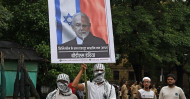 A protester holds a placard showing half the face of Indian Prime Minister Narendra Modi and half of Prime Minister Benjamin Netanyahu during the Palestine solidarity gathering, Mumbai, India, Aug. 20, 2025. (Getty Images Photo)