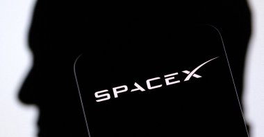 The SpaceX logo and Elon Musk's silhouette are seen in this illustration, Dec. 19, 2022. (Reuters Photo)