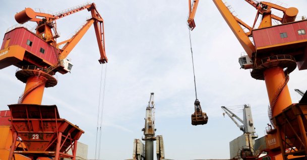 Cranes unload imported iron ore from a cargo vessel at a port in Lianyungang, Jiangsu province, China, Oct. 27, 2019. (Reuters Photo)