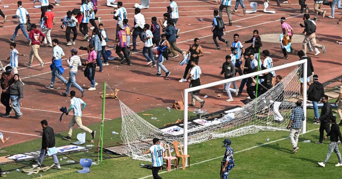 Security personnel try to control the crowd as Argentina's footballer Lionel Messi departs from Salt Lake Stadium during his GOAT Tour in Kolkata, India, Dec. 13, 2025. (AFP Photo)