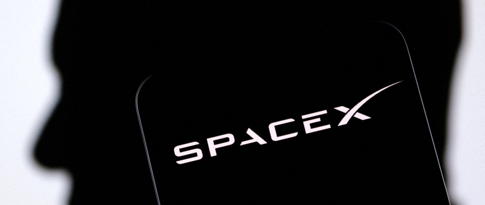 The SpaceX logo and Elon Musk's silhouette are seen in this illustration, Dec. 19, 2022. (Reuters Photo)