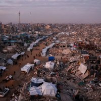 Palestinians walk past tents lining the streets amid the rubble of destroyed buildings in Jabalia, in the northern Gaza Strip, Feb. 18, 2025. (AFP File Photo)