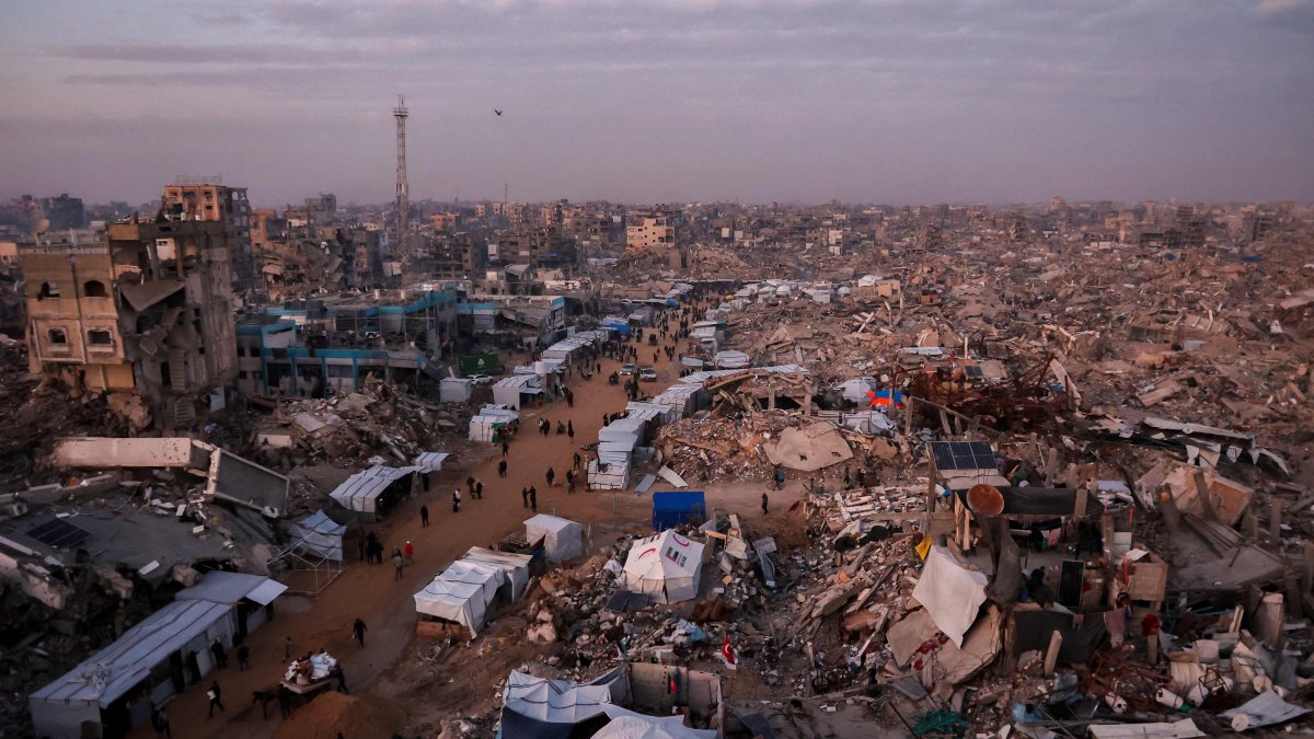 Palestinians walk past tents lining the streets amid the rubble of destroyed buildings in Jabalia, in the northern Gaza Strip, Feb. 18, 2025. (AFP File Photo)