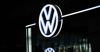 The illuminated VW logo is pictured in the customer centre at the headquarters of German carmaker Volkswagen (VW), Wolfsburg, Germany, Nov. 21, 2025. (AFP Photo)