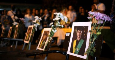 Photographs of students are displayed on school desks during a vigil for victims of a bus accident, outside the Liceo Antioqueno in Bello, Colombia, Dec. 14, 2025. (Reuters Photo)