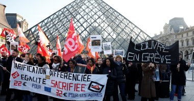 Louvre museum employees on strike hold a banner which reads "Louvre on strike," in Paris, France, Dec. 15, 2025. (Reuters Photo)