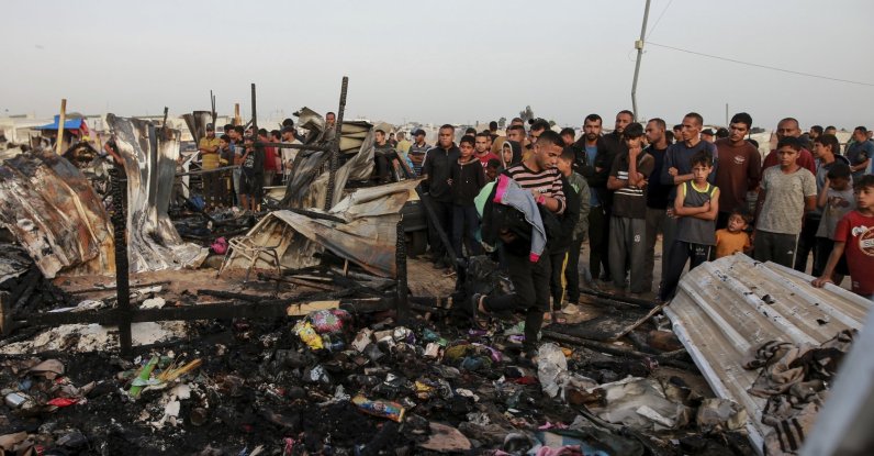 Palestinians look at the destruction after an Israeli strike where displaced people were staying in Rafah, the Gaza Strip, May 27, 2024. (AP Photo)