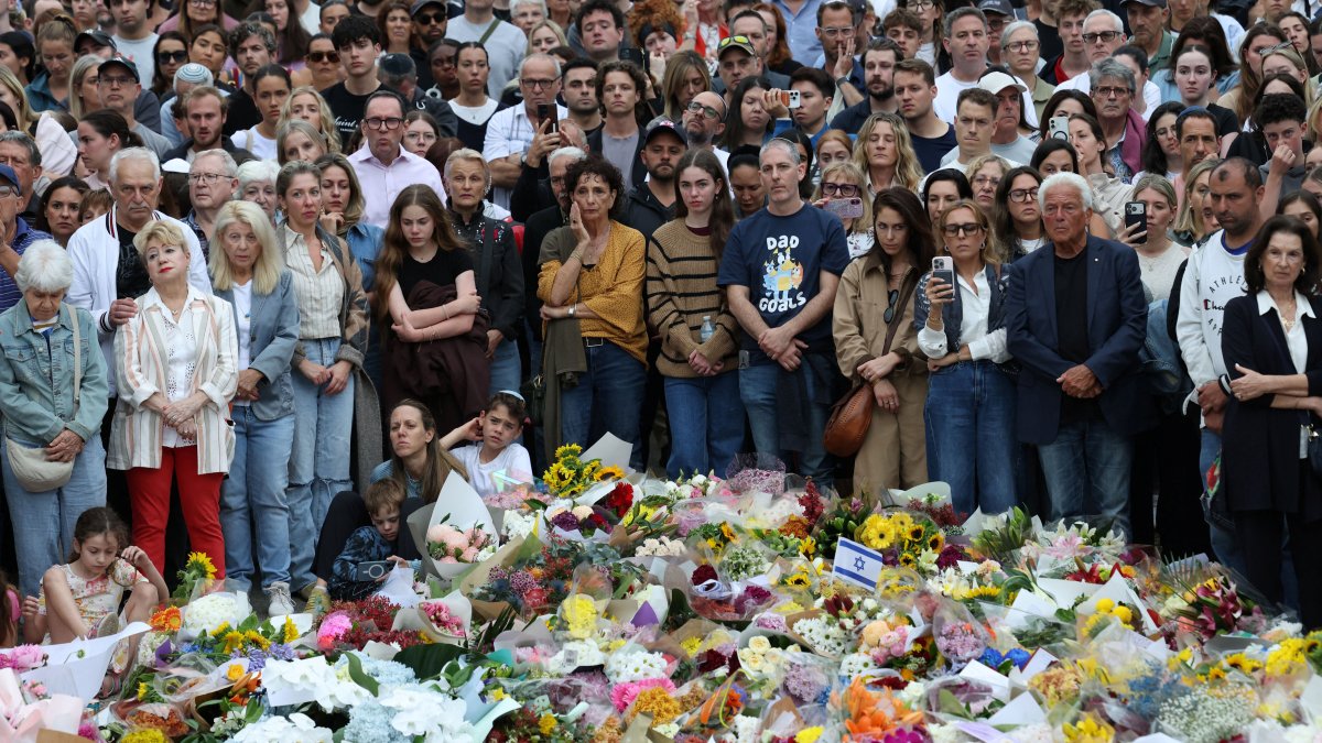 People pay tribute at Bondi Beach during a vigil to honor the victims of a mass shooting that targeted a Jewish holiday celebration on Sunday at Bondi Beach, in Sydney, Australia, Dec. 16, 2025. (Reuters Photo)