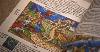 A stock photo of Martin Luther's Bible in the German language opened to the book of Revelation, Chapter 13, showing beasts from the sea and land, Wittenberg, Germany. (Shutterstock Photo)
