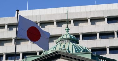 The Japanese flag flutters above the Bank of Japan (BOJ) headquarters, Tokyo, Japan, Dec. 16, 2025. (AFP Photo)