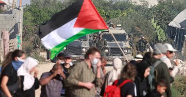 Residents of the Nur Shams refugee camp, near Tulkarem in the Israeli-occupied West Bank, and foreign solidarity activists gather at the entrance of the camp during a protest demanding the right to return to their homes, on Nov. 23, 2025. (AFP Photo)