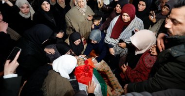 Mourners react next to the body of 16-year-old Palestinian Ammar Sabbah, who was killed by Israeli soldiers in a West Bank raid, during his funeral in Tuqu' near Bethlehem in the Israeli-occupied West Bank, Dec.16, 2025. (Reuters Photo)