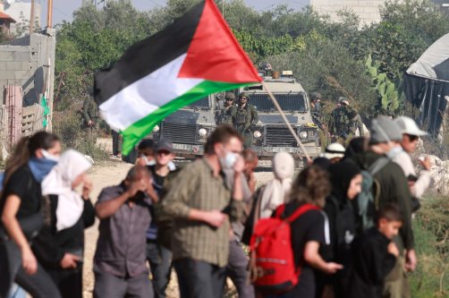 Residents of the Nur Shams refugee camp, near Tulkarem in the Israeli-occupied West Bank, and foreign solidarity activists gather at the entrance of the camp during a protest demanding the right to return to their homes, on Nov. 23, 2025. (AFP Photo)