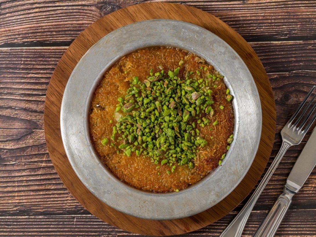 Antakya künefe served with pistachios on top. (Shutterstock Photo)