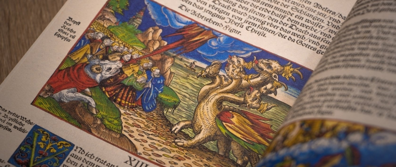 A stock photo of Martin Luther's Bible in the German language opened to the book of Revelation, Chapter 13, showing beasts from the sea and land, Wittenberg, Germany. (Shutterstock Photo)