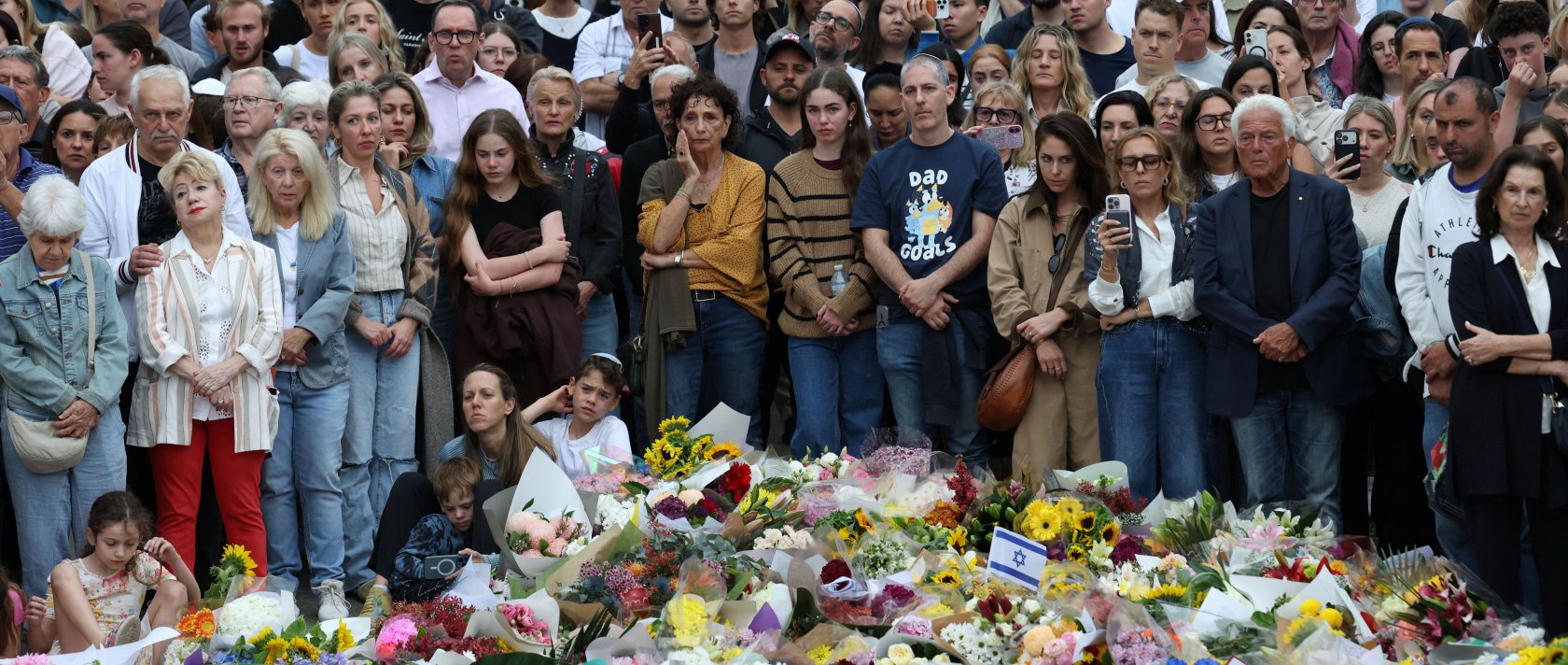 People pay tribute at Bondi Beach during a vigil to honor the victims of a mass shooting that targeted a Jewish holiday celebration on Sunday at Bondi Beach, in Sydney, Australia, Dec. 16, 2025. (Reuters Photo)