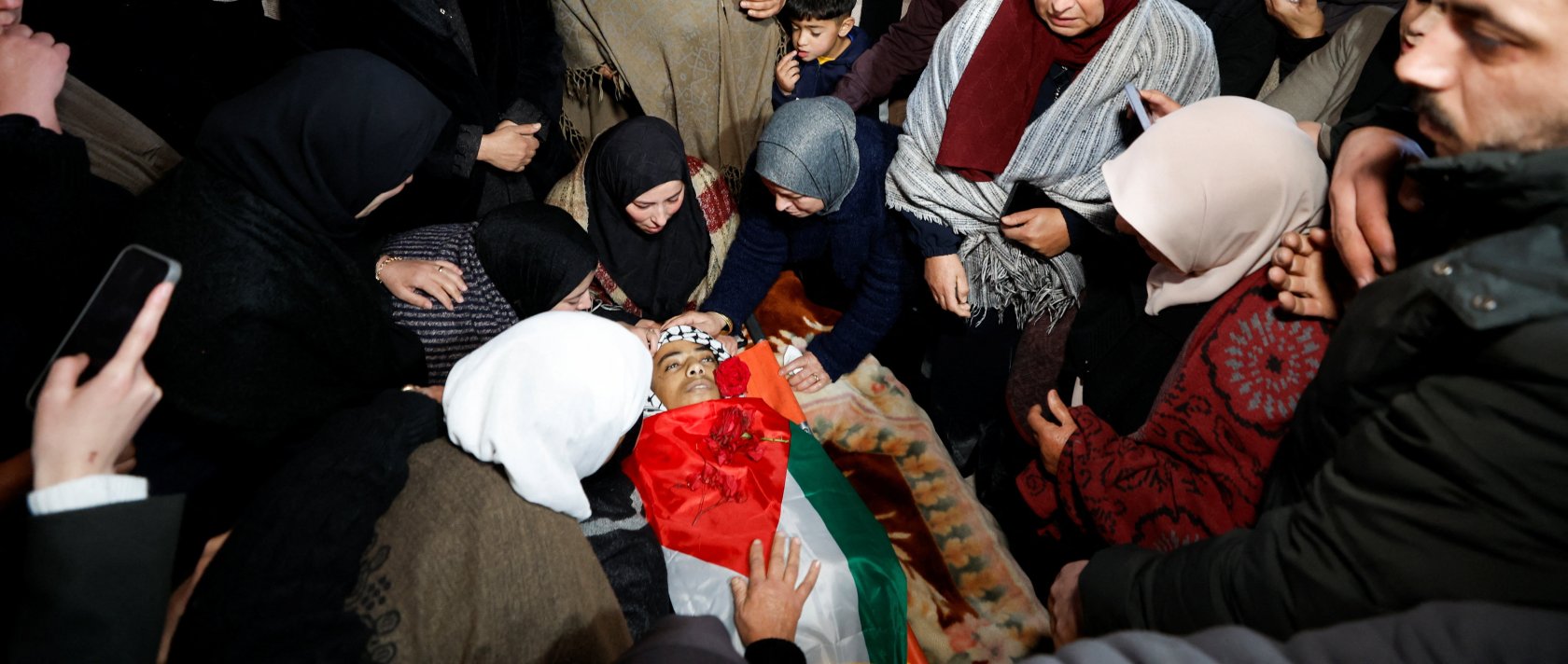 Mourners react next to the body of 16-year-old Palestinian Ammar Sabbah, who was killed by Israeli soldiers in a West Bank raid, during his funeral in Tuqu' near Bethlehem in the Israeli-occupied West Bank, Dec.16, 2025. (Reuters Photo)