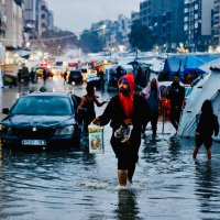 Displaced Palestinians wade through floodwaters following heavy rains in Gaza City, central Gaza Strip, Palestine, Dec. 15, 2025. (AFP Photo)