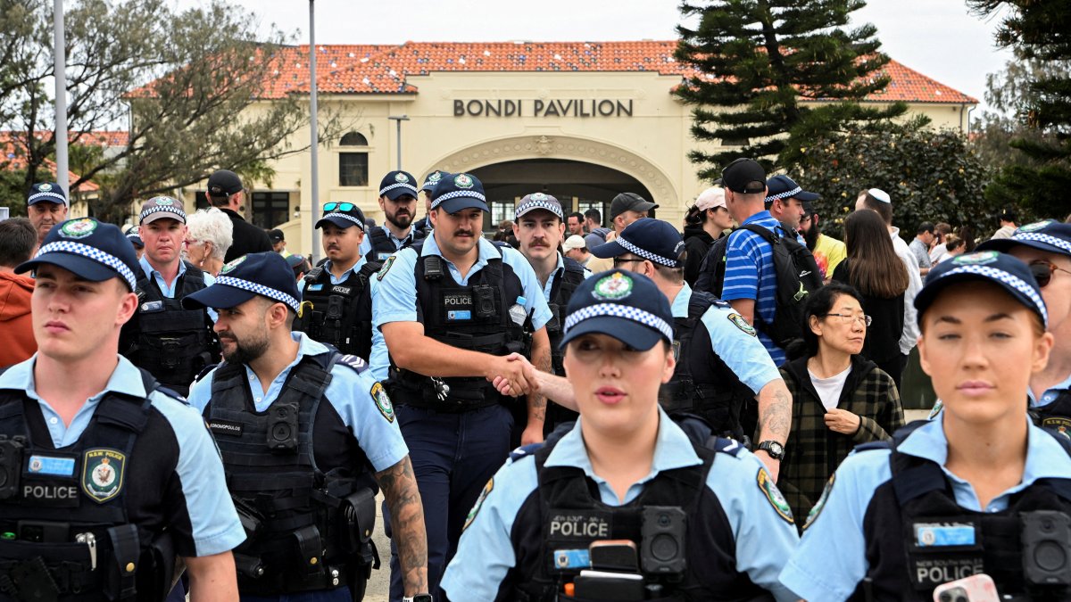 Police officers gather near Bondi Beach pavilion, at the floral memorial to honor the victims of a mass shooting at Bondi Beach, in Sydney, Australia, Dec. 16, 2025. (Reuters Photo)