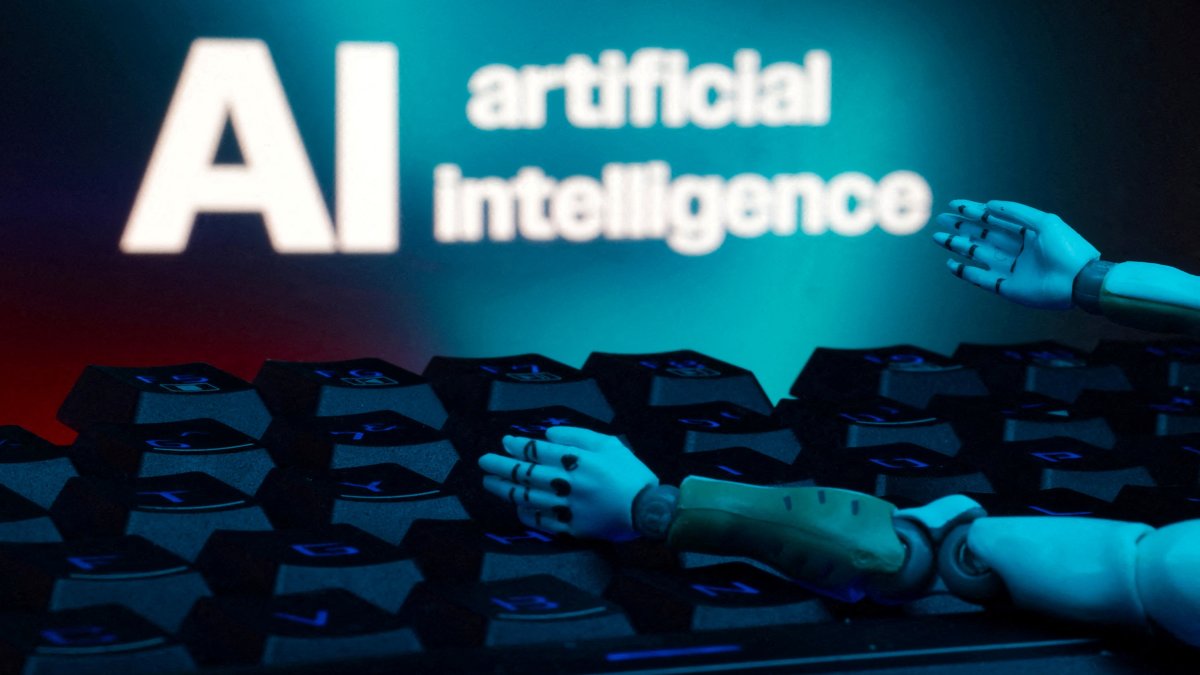 A message reading "AI artificial intelligence," a keyboard and robot hands are seen in this illustration taken on Jan. 27, 2025. (Reuters Photo)