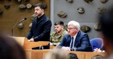 Ukrainian President Volodymyr Zelenskyy (L) delivers a speech next to Ukrainian Foreign Minister Andrii Sybiha (R) at parliament, the Hague, Netherlands, Dec. 16, 2025. (AFP Photo)