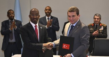 Somali Fisheries and Blue Economy Minister Ahmed Hassan Aden and OYAK CEO Murat Yalçıntaş shake hands as the agreement on cooperation in the fisheries sector is signed, Ankara, Türkiye, Dec. 17, 2025. (AA Photo)