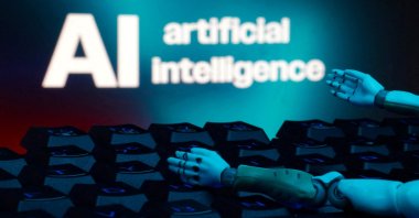 A message reading "AI artificial intelligence," a keyboard and robot hands are seen in this illustration taken on Jan. 27, 2025. (Reuters Photo)
