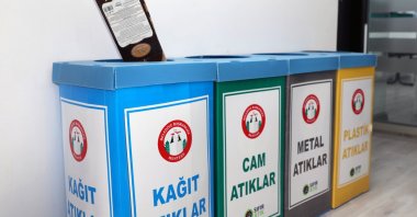 A person is seen placing material for recycling into a designated bin, Muğla, southwestern Türkiye, Nov. 19, 2025. (IHA Photo)