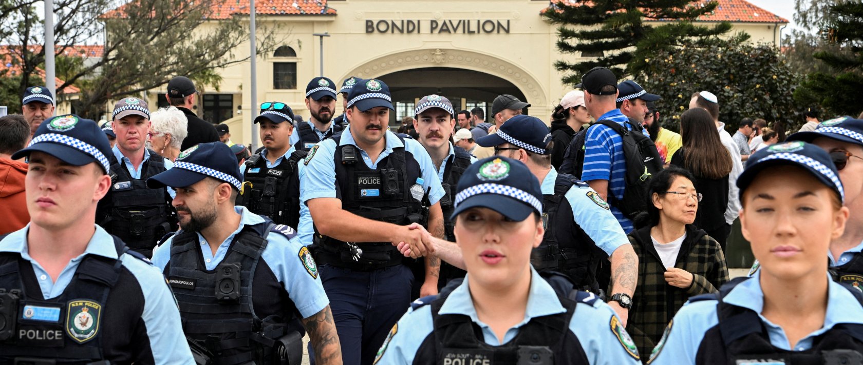 Police officers gather near Bondi Beach pavilion, at the floral memorial to honor the victims of a mass shooting at Bondi Beach, in Sydney, Australia, Dec. 16, 2025. (Reuters Photo)