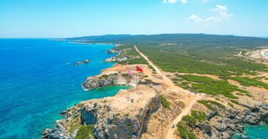 The flags of Türkiye and the Turkish Republic of Northern Cyprus (TRNC) wave at the easternmost tip of the island, Zafer Burnu, Karpaz Peninsula, TRNC, July 19, 2024. (Shutterstock Photo)