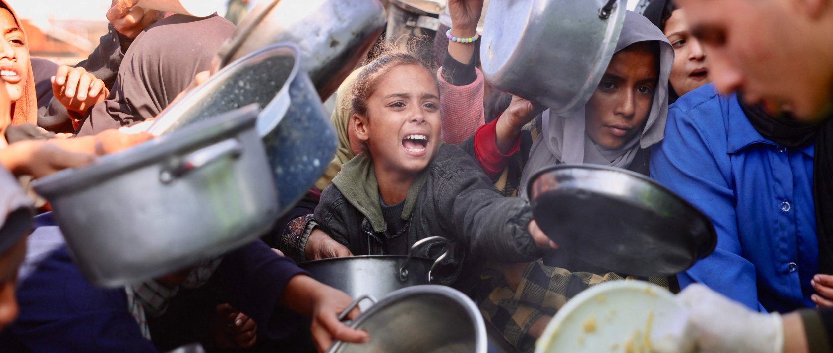 Displaced Palestinians gather to receive donated food portions at a charity kitchen in Khan Younis in the southern Gaza Strip, Palestine, Dec. 17, 2025. (AFP Photo)
