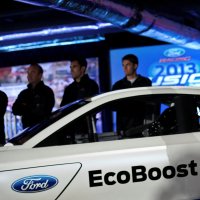 Driver Greg Biffle poses for photographs in front of the new 2013 Ford stock car after an announcement during the NASCAR Media Tour in Concord, North Carolina, U.S., Jan. 24, 2012. (Reuters Photo)