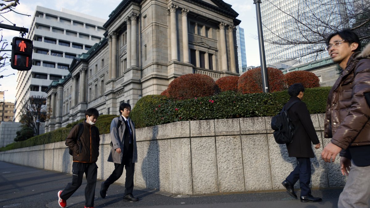 Passersby walk past the Bank of Japan (BOJ) headquarters in Tokyo, Japan, Dec. 19, 2025. (EPA Photo)