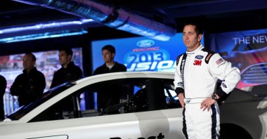 Driver Greg Biffle poses for photographs in front of the new 2013 Ford stock car after an announcement during the NASCAR Media Tour in Concord, North Carolina, U.S., Jan. 24, 2012. (Reuters Photo)