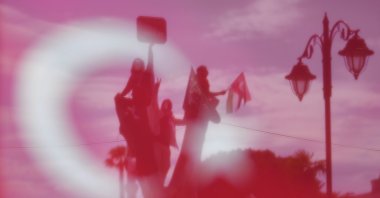 Protesters, seen from behind a Turkish flag, attend a demonstration against Israel's war on Gaza, outside the Grand Hagia Sophia Mosque, Istanbul, Türkiye, June 1, 2025. (AP Photo)