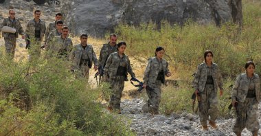 Members of the PKK terrorist group walk to a disarmament ceremony marking a significant step toward ending decades of terrorist attacks, the Qandil mountains, Iraq, Oct. 26, 2025. (Reuters Photo)