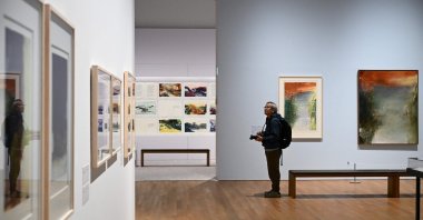 A photographer takes photos at a media preview of M  art museum's special exhibition titled "Zao Wou-Ki: Master Printmaker," the works of Chinese French artist Zao Wou-Ki (1920-2013), one of the most influential abstract artists of the mid- and late 20th century, Hong Kong, China, Dec. 11, 2025. (AFP Photo)