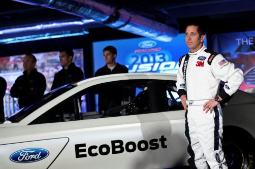 Driver Greg Biffle poses for photographs in front of the new 2013 Ford stock car after an announcement during the NASCAR Media Tour in Concord, North Carolina, U.S., Jan. 24, 2012. (Reuters Photo)