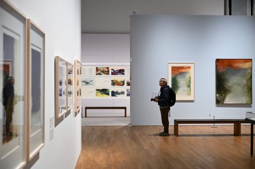 A photographer takes photos at a media preview of M  art museum's special exhibition titled "Zao Wou-Ki: Master Printmaker," the works of Chinese French artist Zao Wou-Ki (1920-2013), one of the most influential abstract artists of the mid- and late 20th century, Hong Kong, China, Dec. 11, 2025. (AFP Photo)