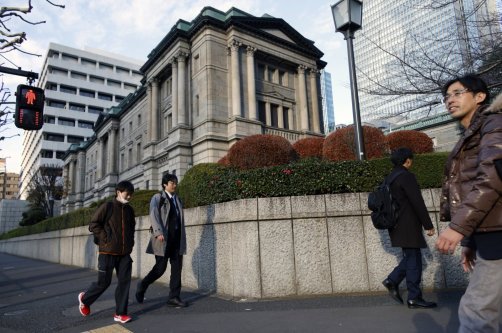 Passersby walk past the Bank of Japan (BOJ) headquarters in Tokyo, Japan, Dec. 19, 2025. (EPA Photo)