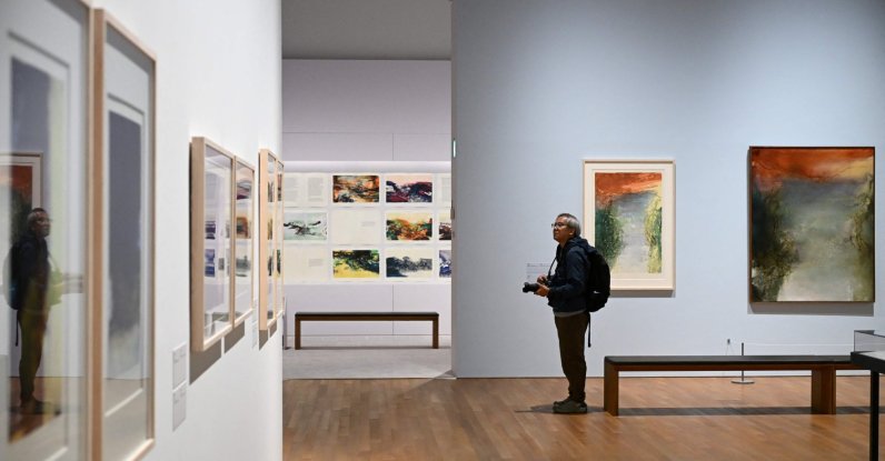 A photographer takes photos at a media preview of M  art museum's special exhibition titled "Zao Wou-Ki: Master Printmaker," the works of Chinese French artist Zao Wou-Ki (1920-2013), one of the most influential abstract artists of the mid- and late 20th century, Hong Kong, China, Dec. 11, 2025. (AFP Photo)