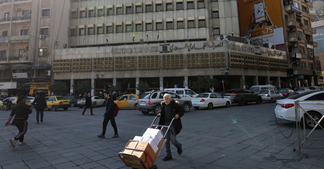 A man walks past the Commercial Bank of Syria, after the National Defense Authorization Act (NDAA) repealed the tough "Caesar" sanctions imposed on Syria under its former leader Bashar Assad, in Damascus, Syria, Dec. 18, 2025. (Reuters Photo)