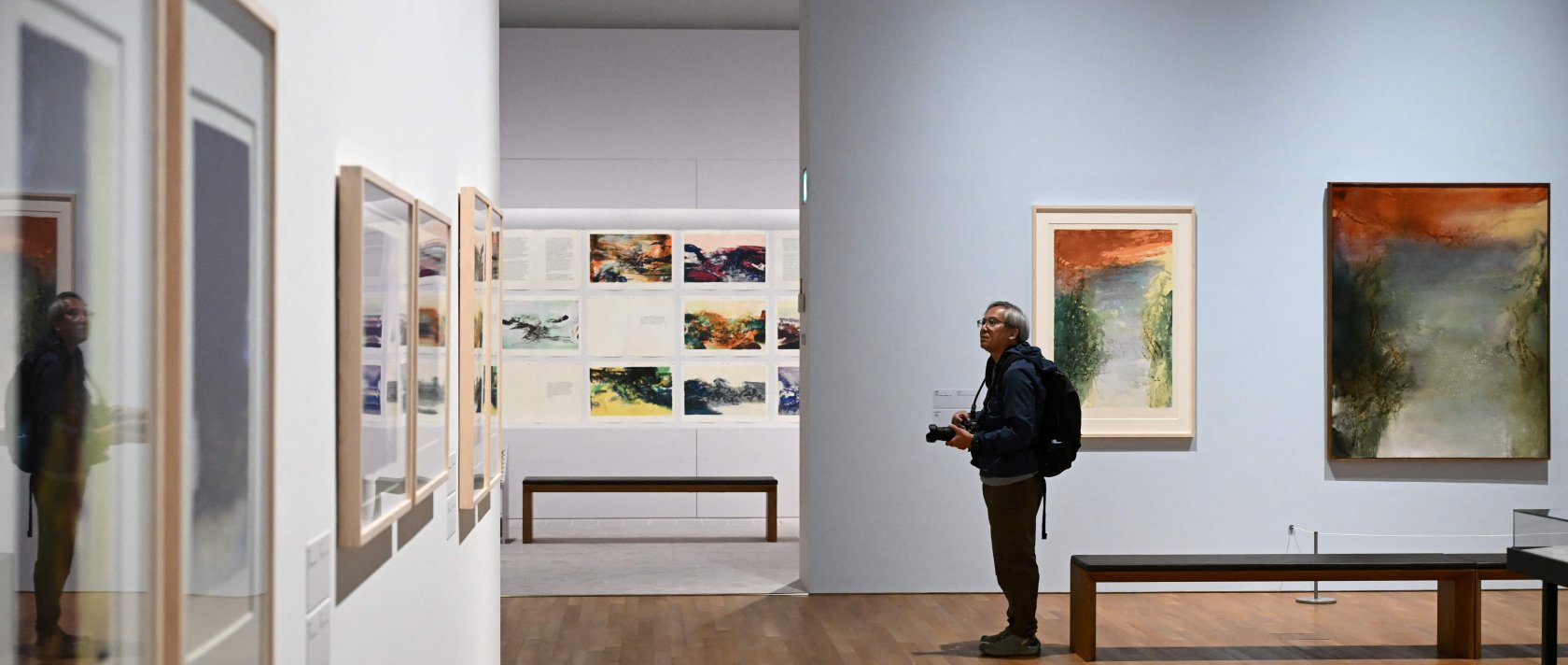 A photographer takes photos at a media preview of M  art museum's special exhibition titled "Zao Wou-Ki: Master Printmaker," the works of Chinese French artist Zao Wou-Ki (1920-2013), one of the most influential abstract artists of the mid- and late 20th century, Hong Kong, China, Dec. 11, 2025. (AFP Photo)