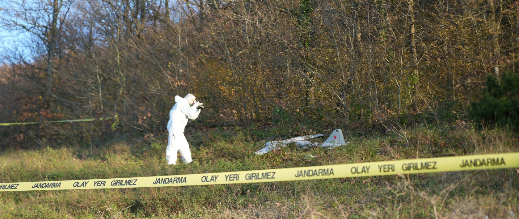 An investigator probes the drone found in Izmit, Kocaeli, Dec. 19, 2025. (IHA Photo)