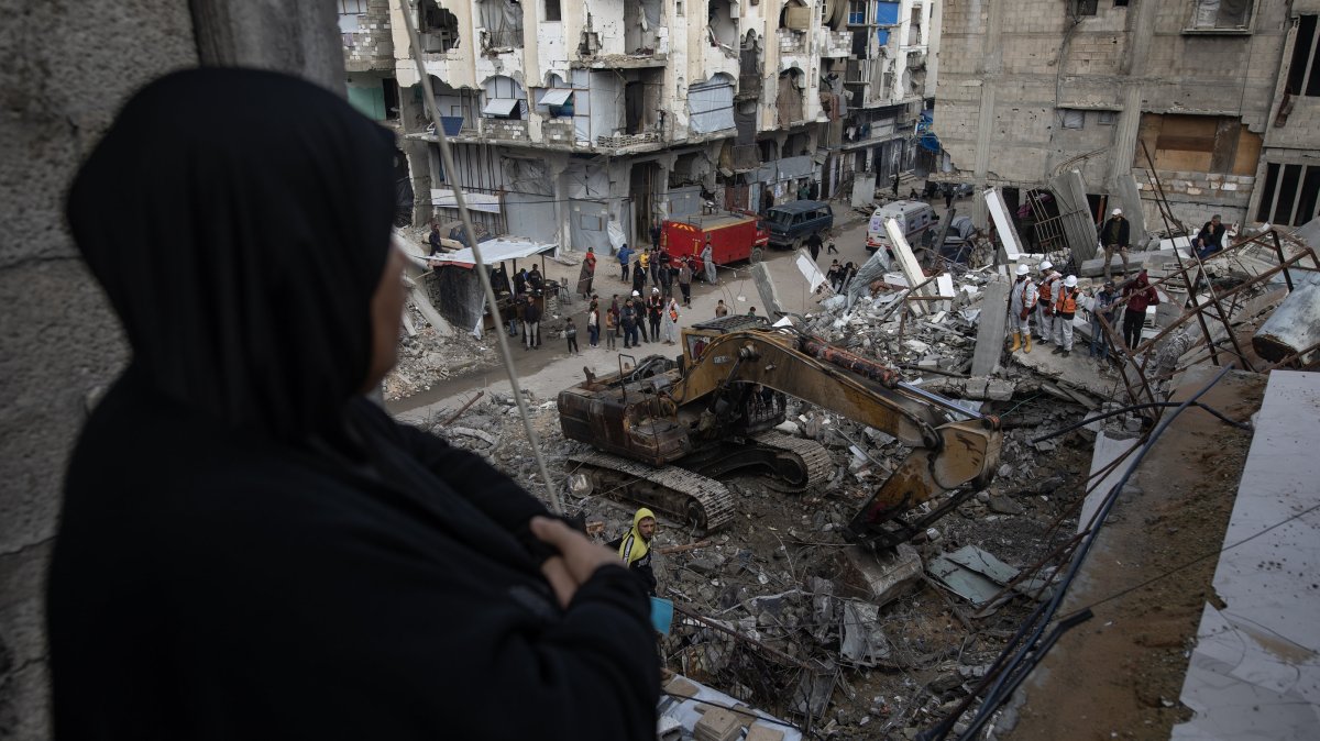 A Palestinian woman watches rescue members remove the rubble of a home destroyed in Israeli airstrikes in Khan Younis, southern Gaza Strip, Palestine, Dec. 20, 2025. (EPA Photo)